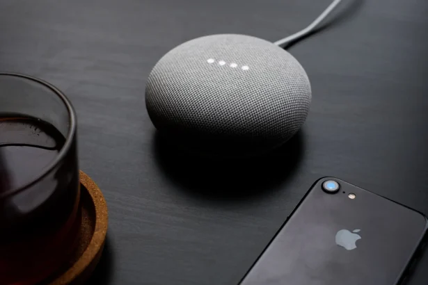 google home mini on a table with iPhone 7