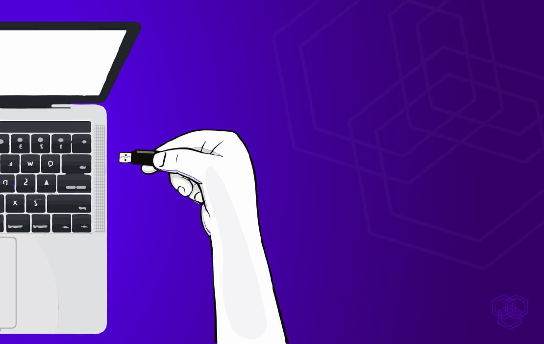 An illustration of a person's hand plugging a USB in a laptop