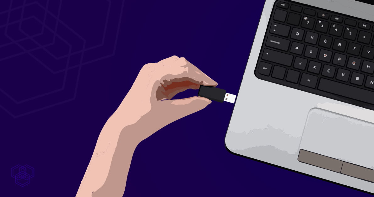 An illustration in which a person is plugging a pendrive in the laptop to create a bootable USB