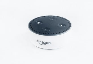 An Amazon echo dot in white