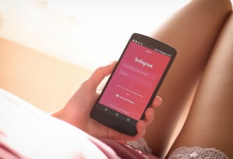 Image contains Nexus 5 Android Smartphone in the hands of a girl with Instagram app open