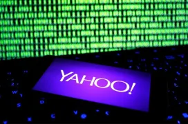Yahoo logo opened in a smartphone in front of a computer screen