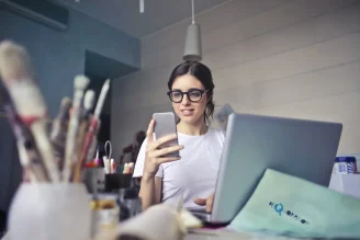 a girl with glasses holding a smartphone, reduce digital eye strain