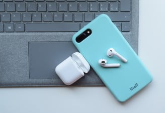 AirPods on a laptop with iPhone 8 plus