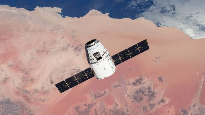A picture of SpaceX's Dragon spacecraft with solar arrays deployed carrying cargo to the International Space Station (ISS) for NASA.