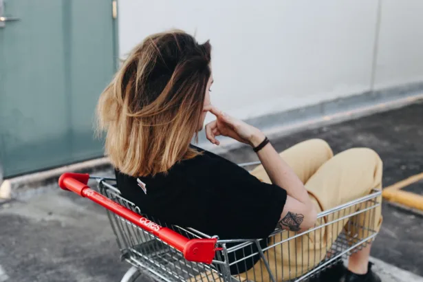 A photo of a girl sitting in a shopping cart