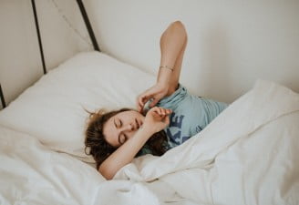 A picture of a girl who appears to be trying to sleep