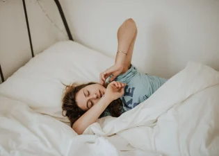 A picture of a girl who appears to be trying to sleep