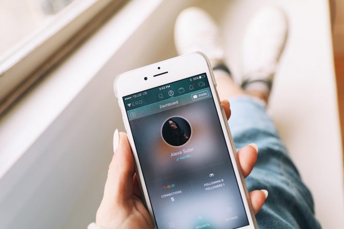 A Photo Of White Iphone In The Hands Of A Girl Running A Social Media App