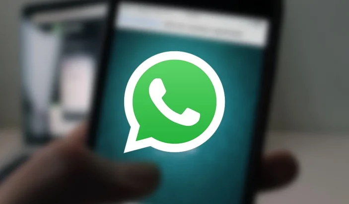 A photo of WhatsApp running on a phone in the background, a featured image for WhatsApp Beta gets forward counter with WhatsApp icon