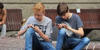 two kids using their phones