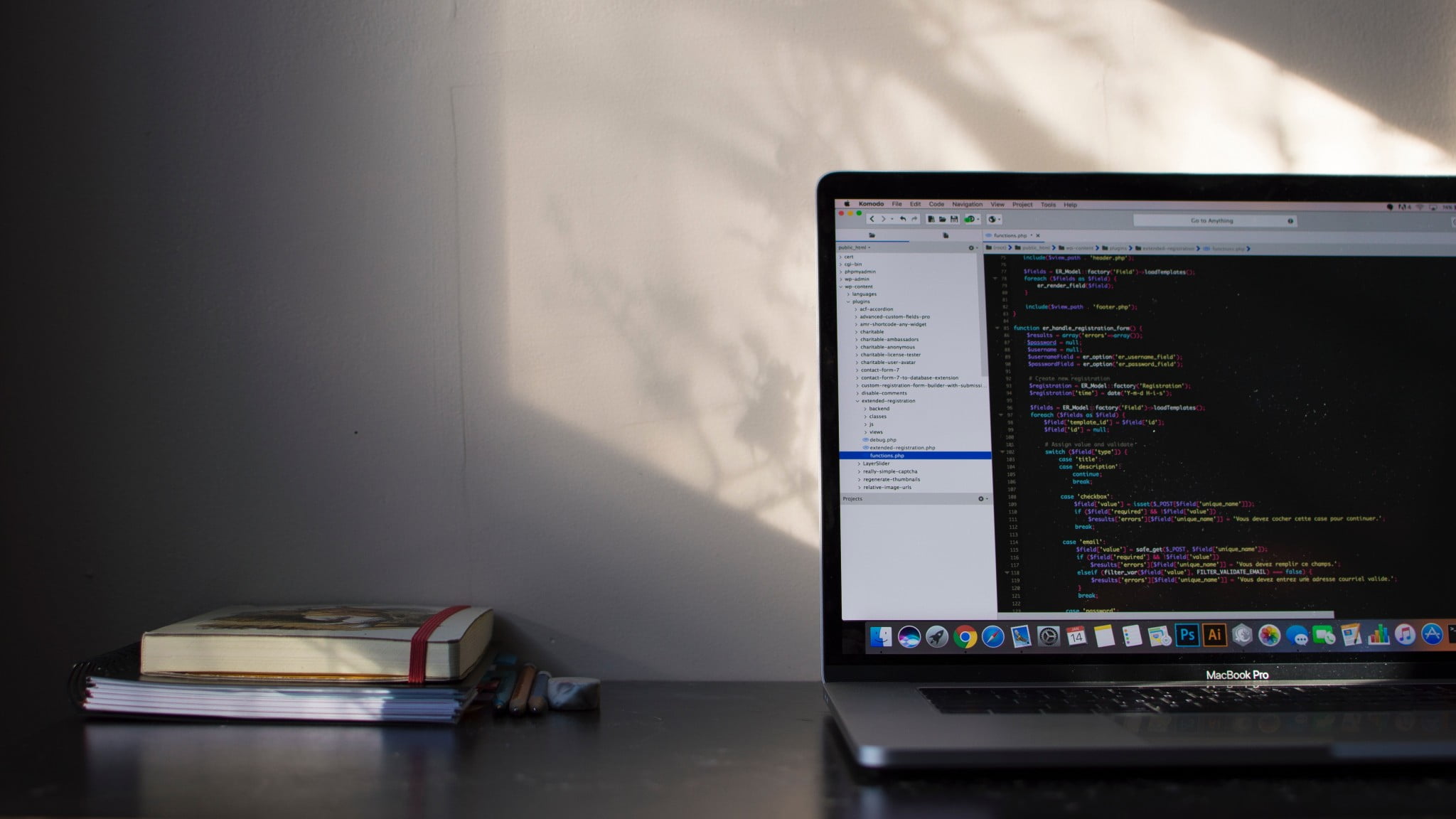 A photo of MacBook Pro with some books placed near it