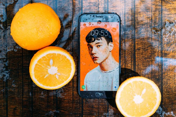 A Photo Of Waterproof Smartphone Near Oranges