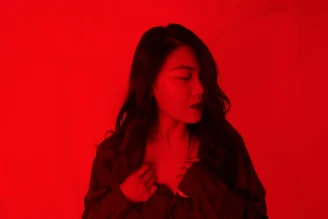 A red tone photo of a girl with anxiety