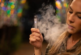 A girl smoking using a vaping device