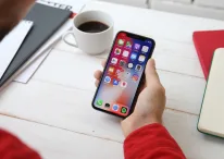 A photo of a person using iOS on iPhone X