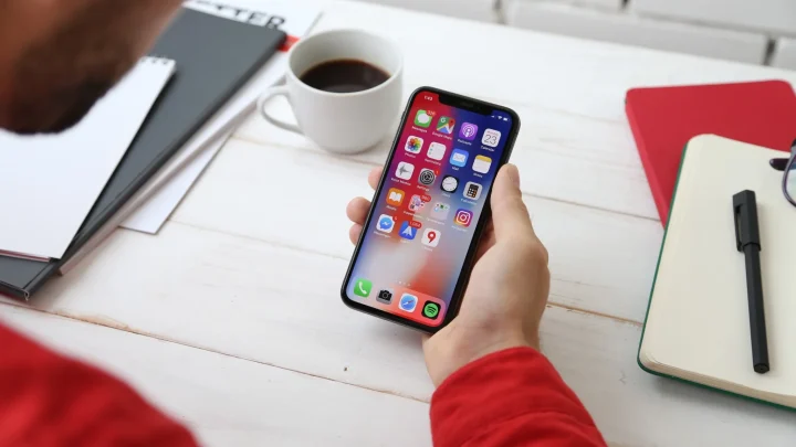 A photo of a person using iOS on iPhone X