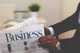 A photo of a businessman reading business newspaper