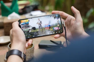A photo of a person playing PUBG on mobile phone