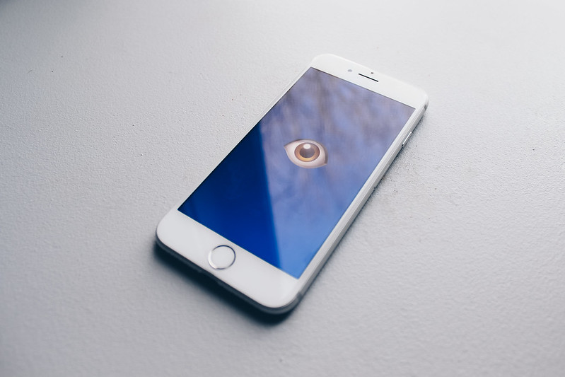 A phone with eye emoji showing privacy breach