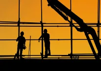 Photo of two labourers working at a construction site