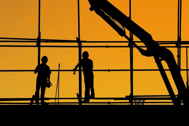 Photo of two labourers working at a construction site