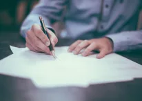 A person signing on a document