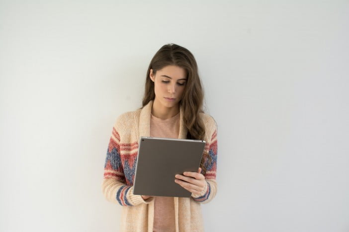 A Woman Proofreading On Ipad