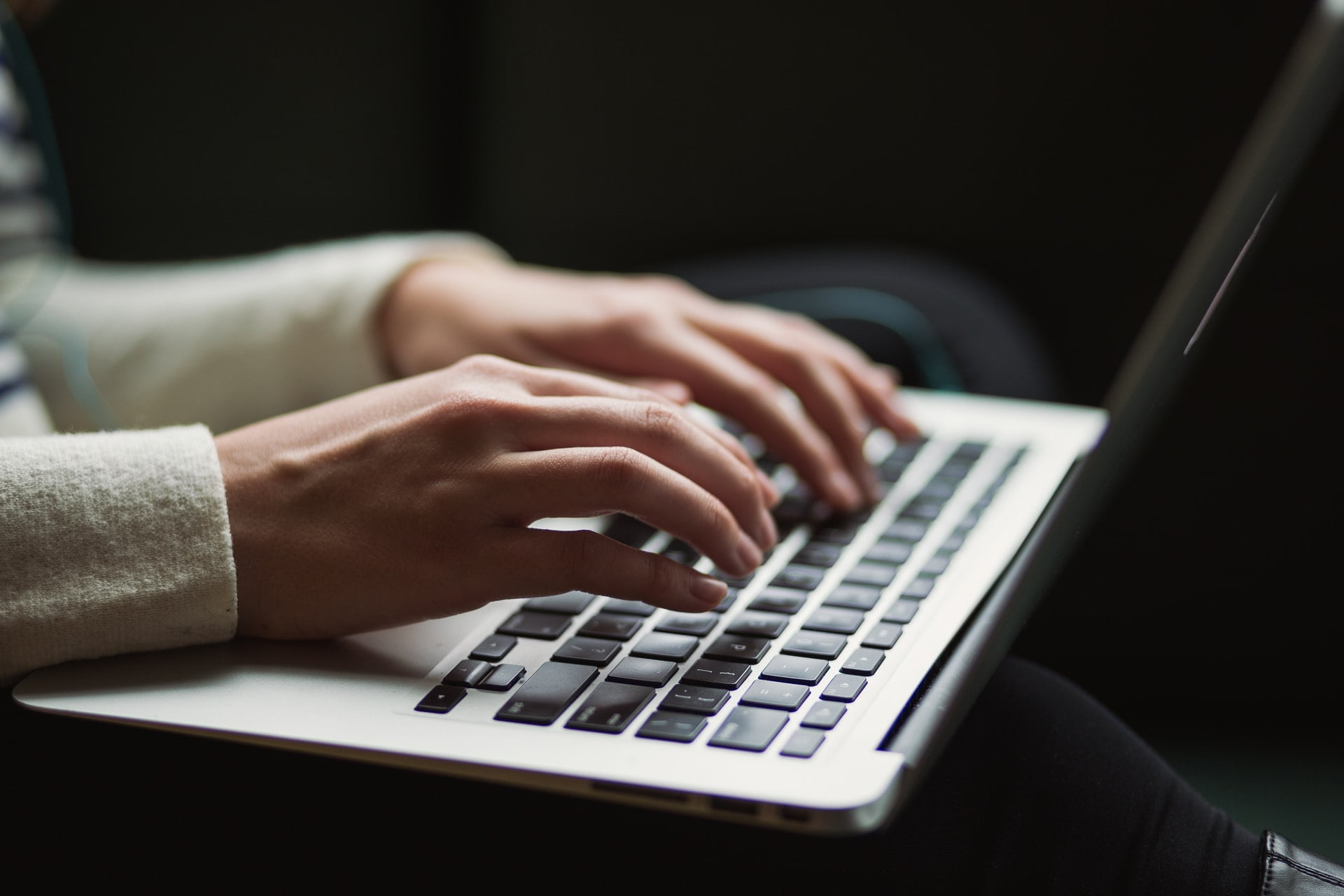 a person typing on laptop