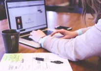 a person typing on a laptop