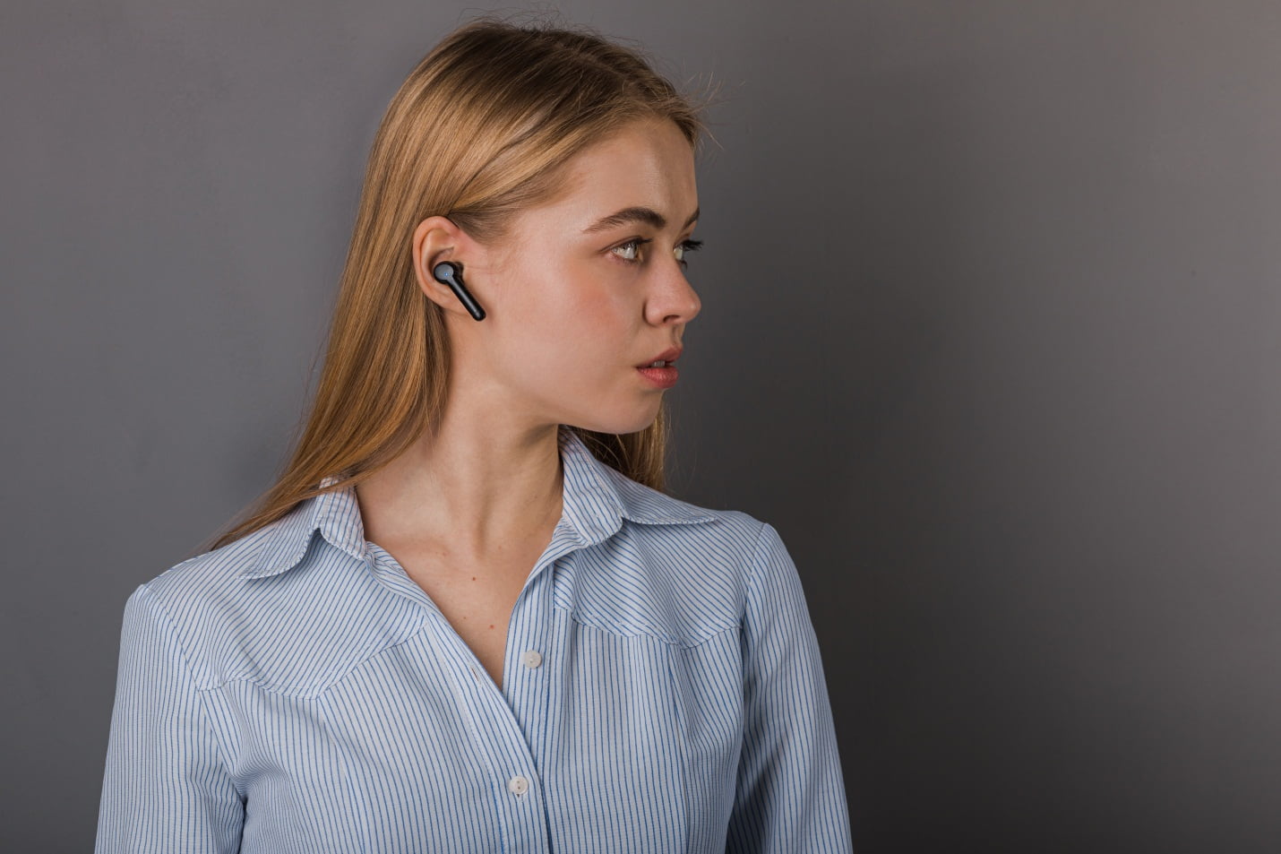 A Girl Wearing Wireless Headphones