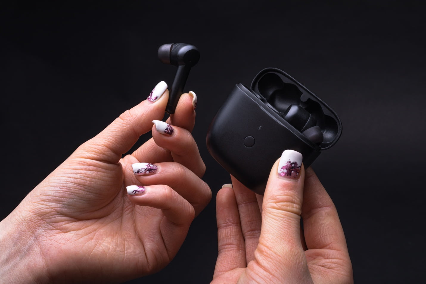 A Girl Holding One Earphone Of Wireless Headphones