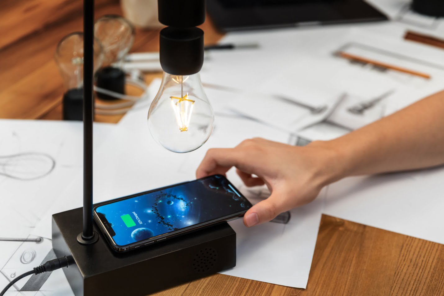 A Woman Placing Her Iphone On The Wireless Charging Pad Of Gravita