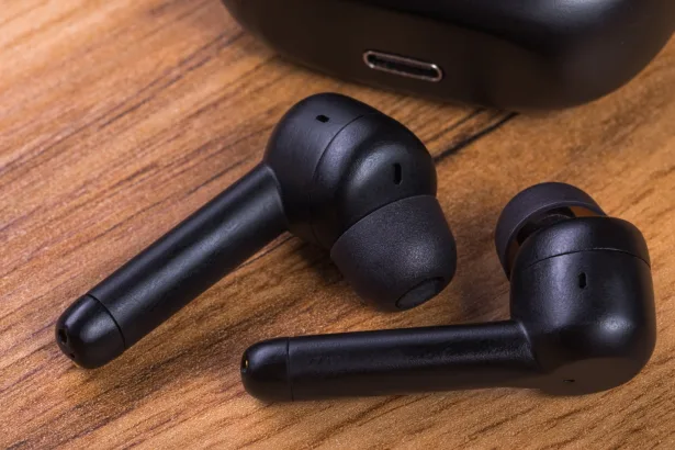 A pair of wireless headphones on a wooden table