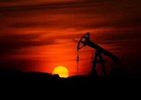 Pump-jack mining crude oil with the sunset