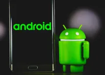 An Android dummy standing near an Android phone