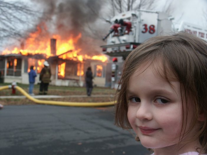 A girl standing alone and the fire in background