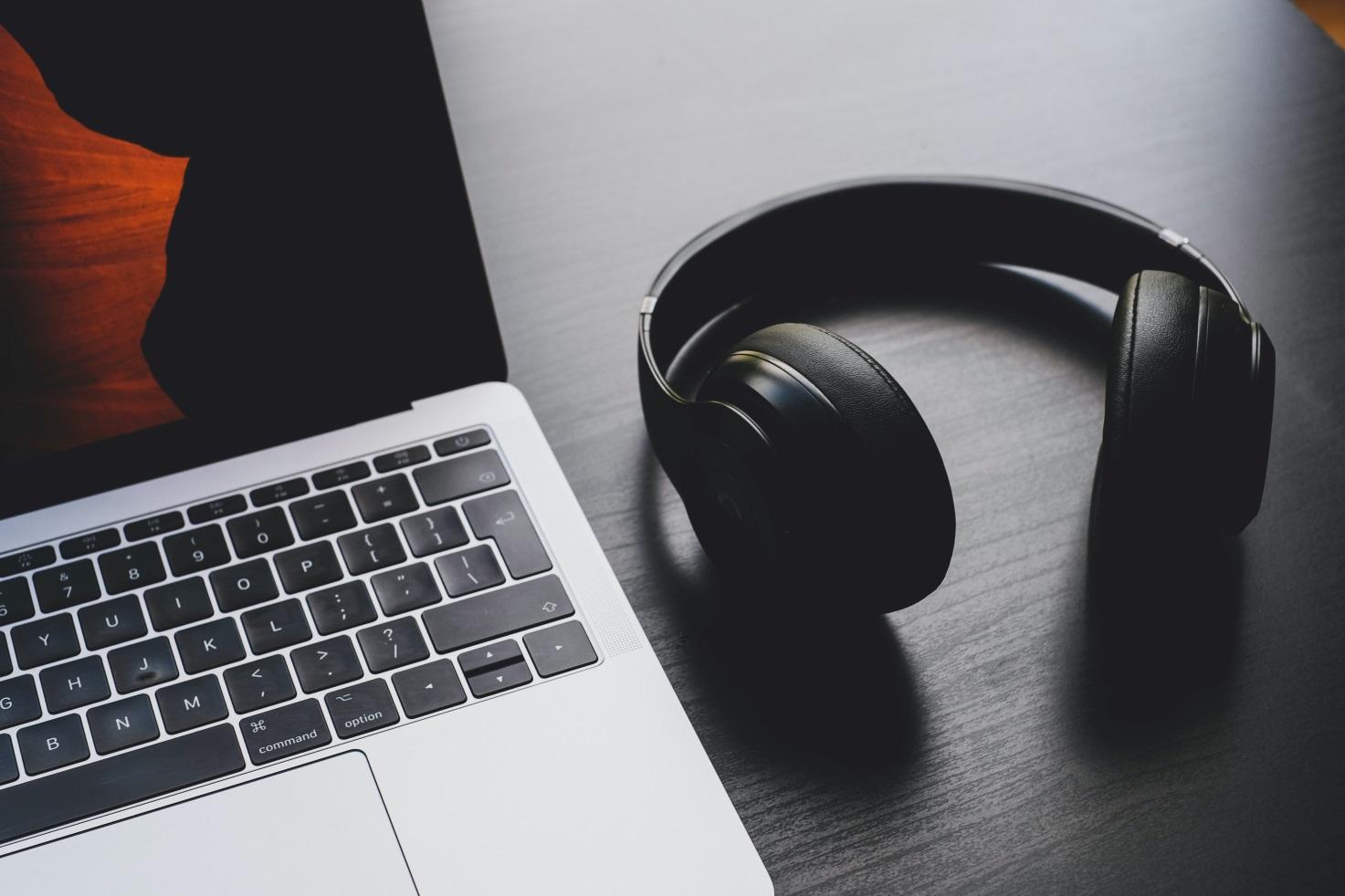 A Photo Of Headphone Placed New A Macbook