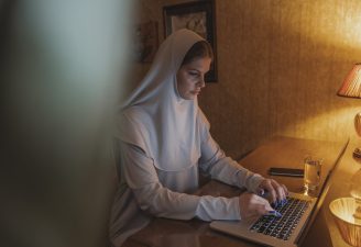 woman in white hijab using laptop computer