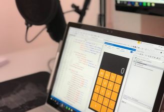 gray laptop computer showing calculator application with codes